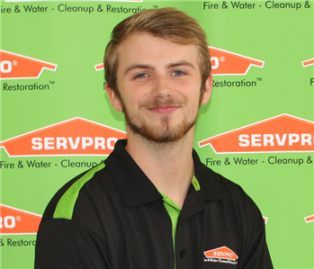 man in front of servpro banner