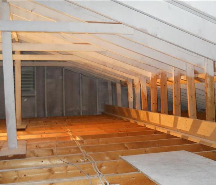 wooden attic with beams exposed and free of mold 