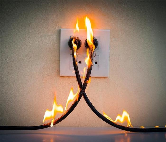 image of electrical chord causing a small fire that has potential to grow rapidly