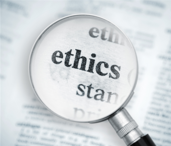 magnifying glass over the word 'ethics'