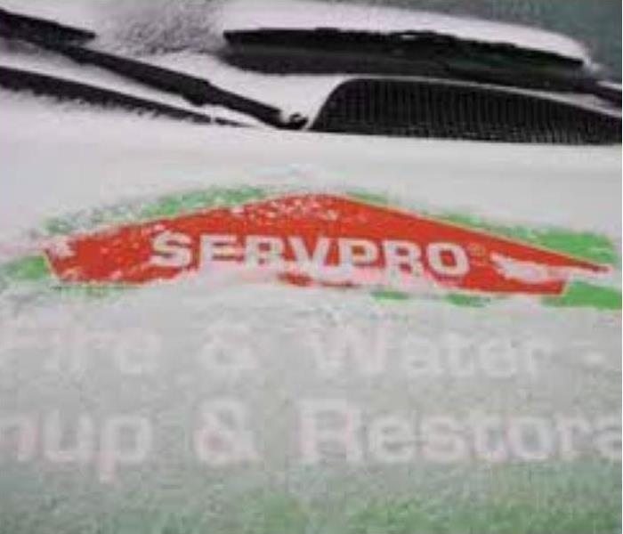 servpro truck with snow covering the hood but logo showing 