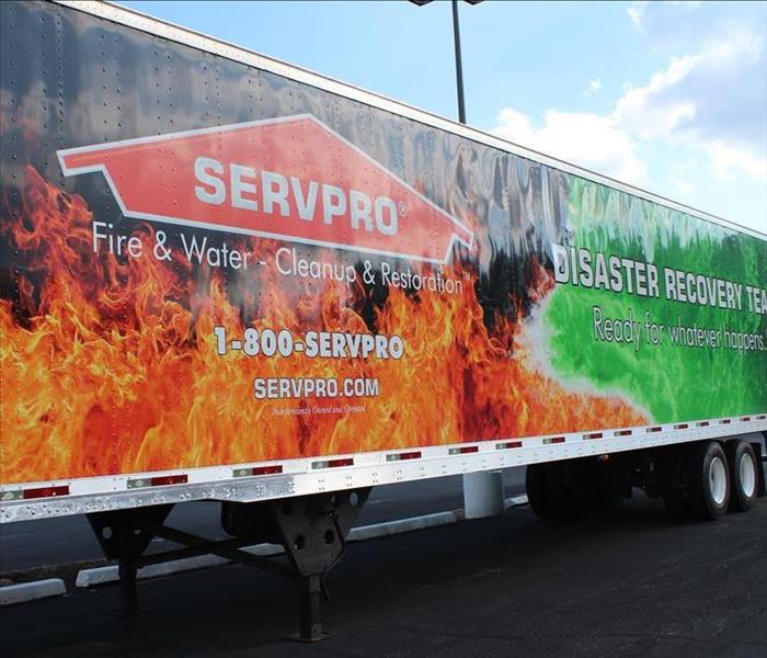 side of SERVPRO semi trailer with fire and water background 